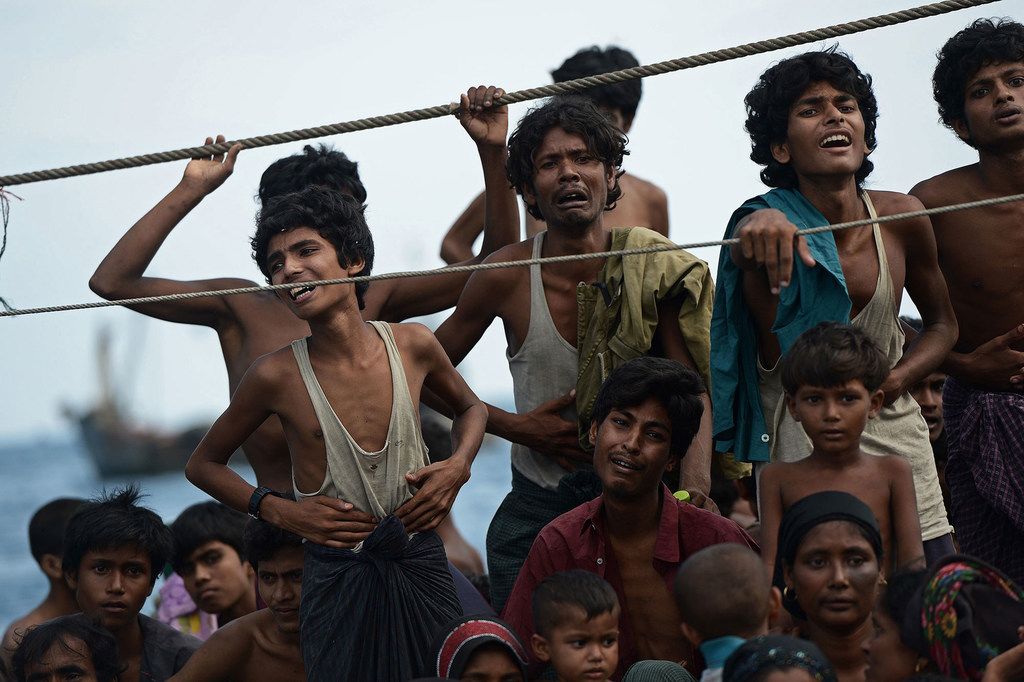 Stranded Rohingya boat people, desperate for food and water, sit on the deck of an abandoned smugglers' boat drifting in Thai waters off the southern island of Koh Lipe in the Andaman sea. (file)